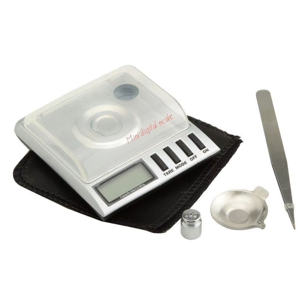 Mini digital scale with a clear protective cover, LCD display, and TARE/MODE/OFF/ON buttons on a white background 0.001g